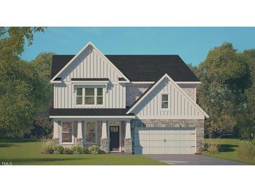 New two-story home featuring a two-car garage, covered porch, brick accents, and eye-catching vertical siding at 405 Falls Bluff Dr, Wake Forest, NC 27596