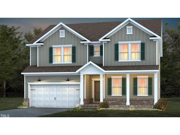 Charming two-story home featuring a two-car garage, green shutters, and inviting front porch at 465 Grange Farm Pl, Raleigh, NC 27603