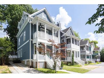Charming two-story home with blue siding, inviting front porch, and landscaped front yard at 507 Rosengarten Aly, Raleigh, NC 27603