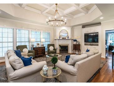 Spacious living room with coffered ceilings, fireplace and lots of natural light at 820 Parkridge Dr, Clayton, NC 27527