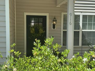 Charming front door adorned with a wreath, offering a welcoming entrance to the home at 916 Woodside Park Ln, Durham, NC 27704