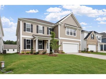 Charming two-story home with a manicured lawn, attached garage, and classic curb appeal at 94 Black Walnut Dr # 201, Garner, NC 27529