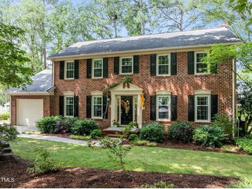 Charming two-story brick home with black shutters and a well-manicured front yard at 1304 Sandpiper Ct, Raleigh, NC 27615