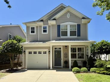 Charming two-story home featuring a well-manicured front yard, attached garage, and inviting front porch at 137 Palmdale Ct, Holly Springs, NC 27540