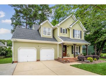 Charming two-story home with a two-car garage, covered porch and manicured landscaping at 2218 Watersglen Dr, Apex, NC 27502