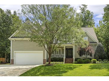Charming home featuring a beautiful lawn and a two-car garage, providing ample space for parking at 4221 Bibleway Ct, Holly Springs, NC 27540