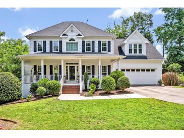 Charming two-story home with a welcoming front porch and well-manicured landscaping at 100 Highfield Ave, Cary, NC 27519