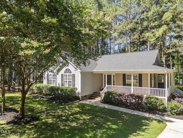 Charming single-story home with a cozy front porch and meticulously landscaped yard at 101 Abram Way, Clayton, NC 27520