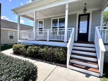 Charming front porch featuring white railing, stairs, and a gray exterior at 118 Chestnut St, Durham, NC 27707