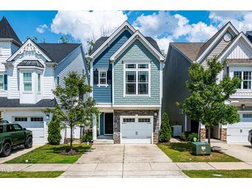 Charming two-story home with stone accents, an attached garage, and a well-manicured lawn at 1363 Brown Velvet Ln, Apex, NC 27523