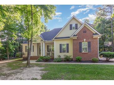 Charming home featuring a blend of siding and brickwork with a well-manicured lawn at 15 Cole Creek Way, Franklinton, NC 27525