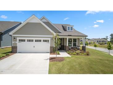 Charming single-Gathering home with a two-car garage, manicured lawn and inviting front porch at 1633 Hillstar St, Fuquay Varina, NC 27526