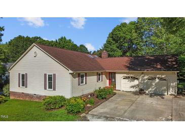 Charming ranch home featuring a two-car garage, well-maintained lawn, and tasteful landscaping at 2257 Delaney Dr, Burlington, NC 27215