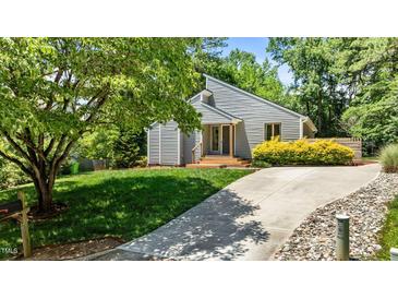Charming home showcasing a well-manicured lawn and concrete driveway leading up to the front entrance and a tree at 7309 Forest Glade Ct, Raleigh, NC 27615