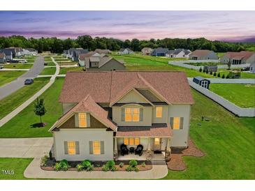 Inviting two-story home with a charming front porch and well-manicured lawn at 81 Olive Branch Dr, Smithfield, NC 27577