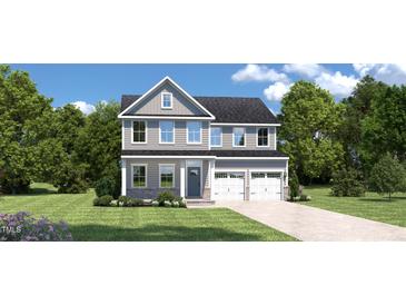 Charming two-story home with blue accents, a well-manicured lawn, and an attached two-car garage at 882 Nichols View Ct, Raleigh, NC 27604