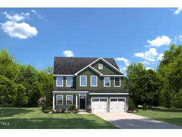 Charming two-story home with a well-manicured lawn, two-car garage, and classic architectural details at 892 Nichols View Ct, Raleigh, NC 27604