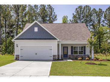 Charming single-Gathering home with a two-car garage, manicured lawn, and welcoming curb appeal at 1004 Rhino Bnd, Oxford, NC 27565