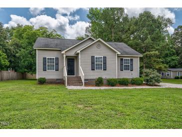 Charming single-story home featuring a well-maintained lawn and classic curb appeal with inviting front entrance and dark shutters at 1203 First Street Ext, Nashville, NC 27856