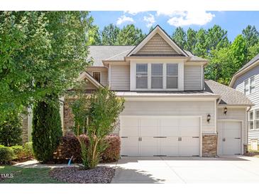Charming two-story home with a three car garage and manicured landscaping at 1413 Lily Creek Dr, Cary, NC 27518