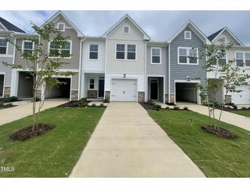 Charming new construction townhomes with attached garages and welcoming front yards at 231 Paramount Dr, Smithfield, NC 27577