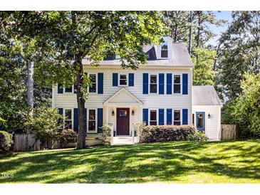 Charming two-story home with blue shutters and a well-manicured lawn at 2409 Basil Dr, Raleigh, NC 27612