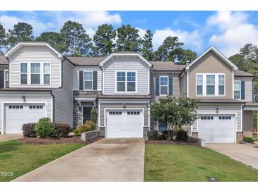 Charming townhomes with attached garages, manicured lawns, and professionally landscaped front yards at 287 White Oak Ridge Dr, Garner, NC 27529