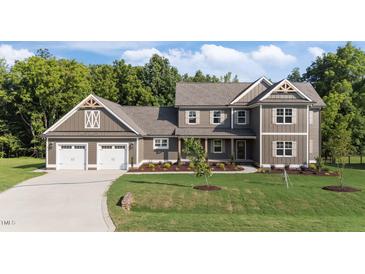 Beautiful two-story home featuring a three-car garage and a well-manicured lawn at 543 Allessandra Dr, Clayton, NC 27527