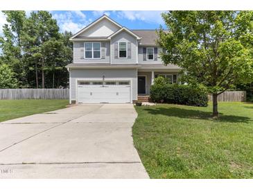 Charming two-story home features a two-car garage and a well-maintained lawn at 767 Omaha Dr, Broadway, NC 27505