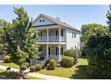 Charming two-story home with a inviting double porch and landscaped yard at 915 Chapanoke Rd, Raleigh, NC 27603