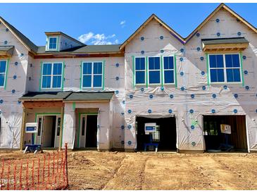 New construction townhomes featuring a modern design with large windows, and garage at 165 Ripple Way # 205, Clayton, NC 27520