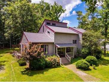 Charming two-story home with a well-maintained front yard and colorful landscaping at 206 Lisa Dr, Carrboro, NC 27510