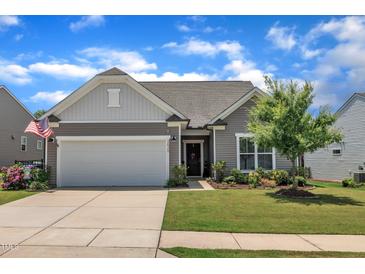 Charming single-story home featuring a two-car garage, well-maintained lawn, and inviting curb appeal at 2626 Nassau Trce, Fuquay Varina, NC 27526