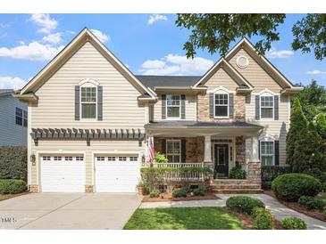 Charming two-story home featuring a stone and siding exterior, a two-car garage, and beautifully landscaped front yard at 2941 Grandview Heights Lane Ln, Raleigh, NC 27614