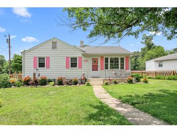 Charming home with pink shutters and a well-manicured lawn creates an inviting curb appeal at 302 Bradley St, Burlington, NC 27215