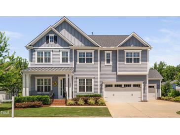 Charming two-story home with a well-maintained lawn, attached garage, and inviting curb appeal at 408 Brierley Dr, Apex, NC 27523