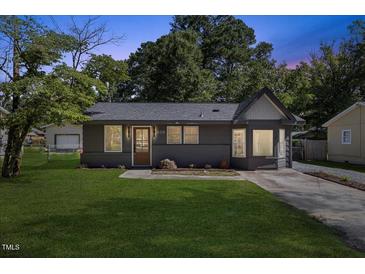 Charming single-story home featuring a freshly painted exterior and a well-manicured front lawn at 506 W Walnut St, Selma, NC 27576