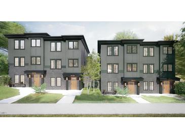 Charming townhomes feature modern design, gray siding, brick accents, and well-manicured landscaping for curb appeal at 1017 N Buchanan Blvd # C, Durham, NC 27701