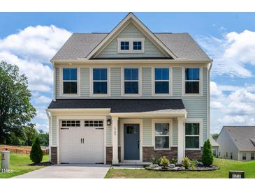 Charming two-story home featuring a well-maintained front yard and a classic architectural design at 1745 Ripley Woods St, Wake Forest, NC 27587