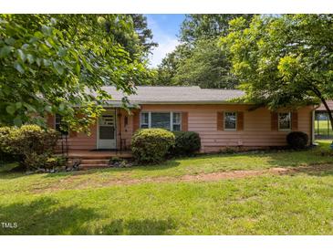 Charming single-story home with a well-maintained front yard and mature landscaping at 416 Forrest St, Hillsborough, NC 27278