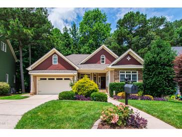 Charming home featuring well-manicured lawn and meticulously landscaped front yard at 553 Lake Gaston Dr, Fuquay Varina, NC 27526