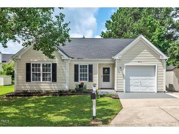 Charming single-story home featuring a well-maintained lawn, attached garage, and inviting curb appeal at 611 Quartz Dr, Durham, NC 27703
