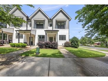 Charming two-story townhouse with gray and white exterior and well-manicured landscaping at 6300 Pleasant Pines Dr # 101, Raleigh, NC 27613