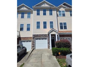 Charming townhome with stone accents, three stories and attached garages at 650 Ganyard Farm Way # 32, Durham, NC 27703