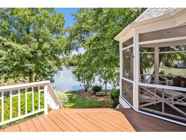 Inviting screened porch offers serene lake views and access to an outdoor deck at 81002 Alexander, Chapel Hill, NC 27517