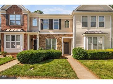 Charming townhome with stone accents, a well-manicured lawn, and a welcoming front entryway at 8422 Central Dr, Raleigh, NC 27613
