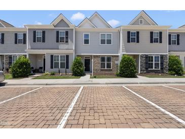 Charming townhome with gray siding, black shutters, and neat landscaping at 8885 Commons Townes Dr, Raleigh, NC 27616