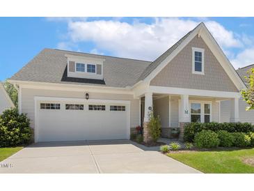 Charming home featuring a two-car garage, covered porch, and well-maintained landscaping at 149 Ivory Ln, Raleigh, NC 27610