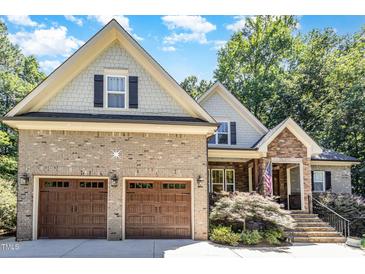 Charming two-story home with a two-car garage, beautiful brick facade and manicured landscaping at 150 Luxorwind Dr, Garner, NC 27529