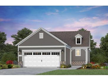 Detached two-car garage showcasing a white carriage door and gray horizontal siding at 173 Churchill Way, Clayton, NC 27520